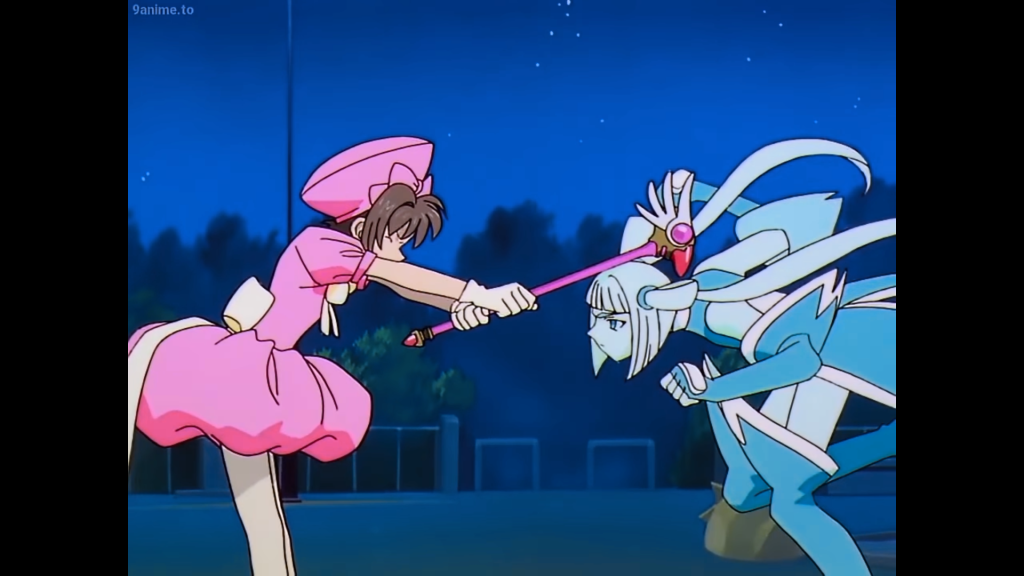 Cardcaptor Sakura Sakura Kinomoto hitting an enemy over the head in the Cardcaptor Sakura anime series.